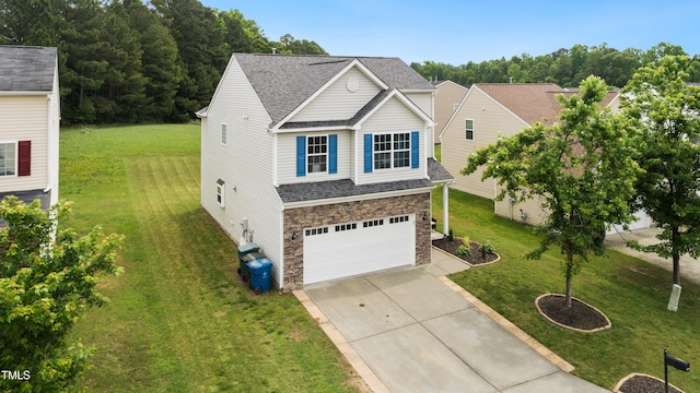 2004 Tennessee Rd, Durham, NC 27704 - traditional-style home featuring stone siding, concrete driveway, a garage, and a front yard