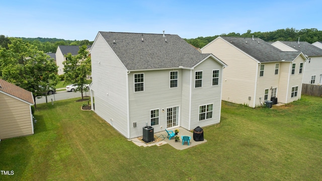 2004 Tennessee Rd, Durham, NC 27704 - rear view of house featuring a patio, a yard, roof with shingles, and central AC unit