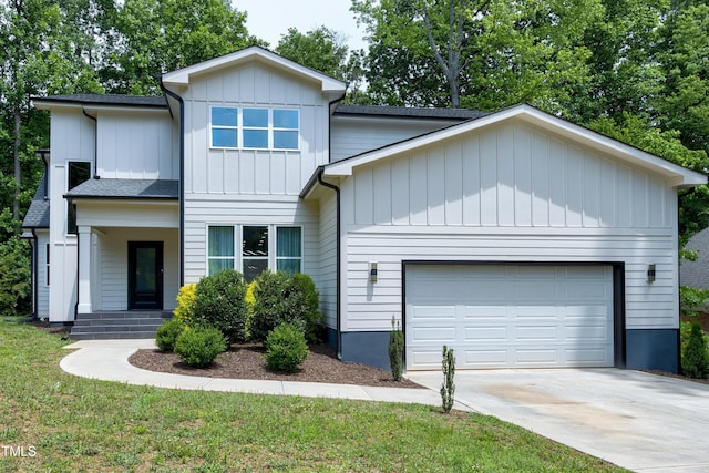 1003 E Sterlington Pl, Apex, NC 27502 - view of front facade featuring an attached garage, concrete driveway, board and batten siding, covered porch, and roof with shingles