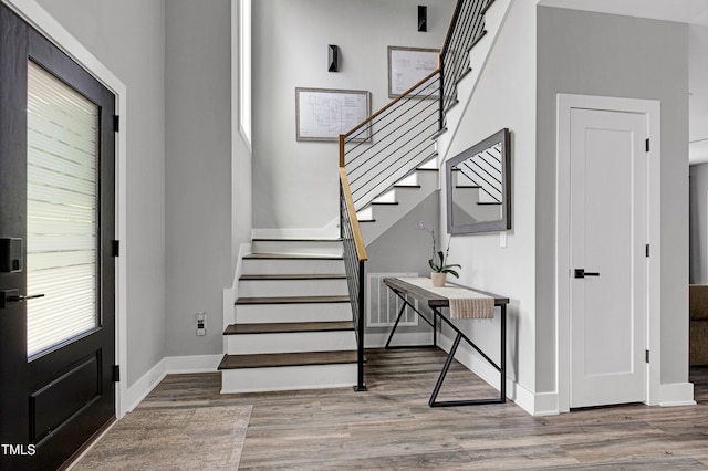 1003 E Sterlington Pl, Apex, NC 27502 - foyer featuring wood finished floors, stairway, and baseboards