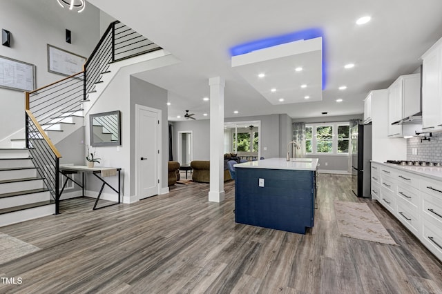 1003 E Sterlington Pl, Apex, NC 27502 - kitchen featuring stainless steel appliances, dark wood finished floors, a sink, a center island with sink, and recessed lighting