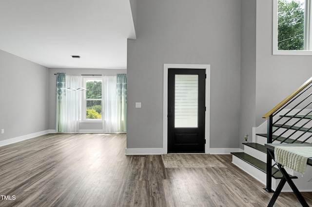 1003 E Sterlington Pl, Apex, NC 27502 - entryway featuring stairway, healthy amount of natural light, wood finished floors, and baseboards