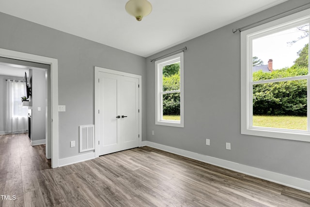 1003 E Sterlington Pl, Apex, NC 27502 - unfurnished bedroom with wood finished floors, baseboards, and a closet