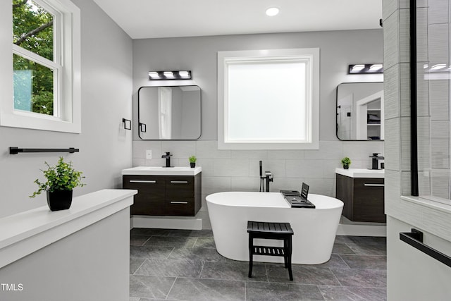 1003 E Sterlington Pl, Apex, NC 27502 - full bathroom with a soaking tub, two vanities, tasteful backsplash, and recessed lighting