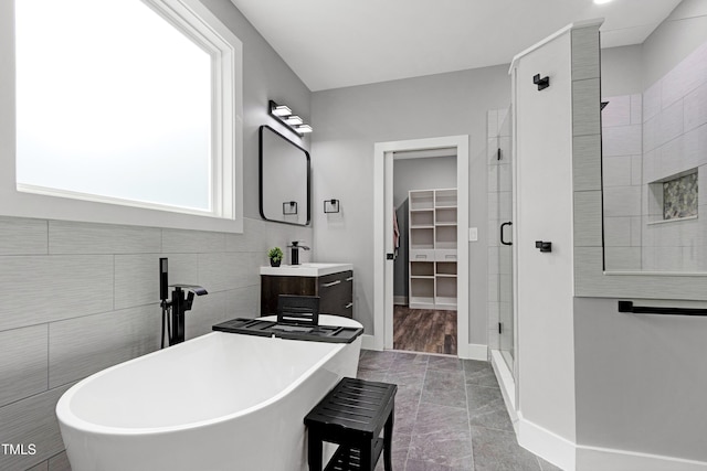 1003 E Sterlington Pl, Apex, NC 27502 - bathroom with a shower stall, a spacious closet, a freestanding tub, and vanity