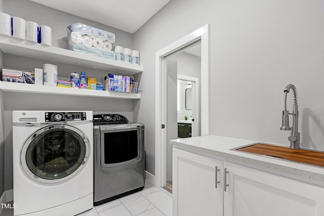 1003 E Sterlington Pl, Apex, NC 27502 - washroom with washer and clothes dryer, light marble finish floors, and cabinet space