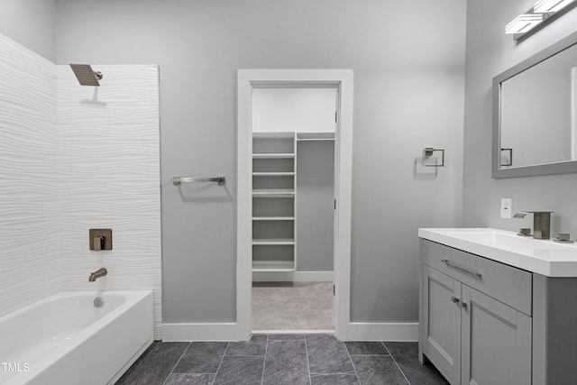 1003 E Sterlington Pl, Apex, NC 27502 - bathroom featuring vanity, tub / shower combination, baseboards, and a spacious closet