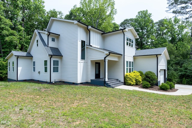 1003 E Sterlington Pl, Apex, NC 27502 - view of front of home featuring a garage, crawl space, a front yard, a shingled roof, and board and batten siding