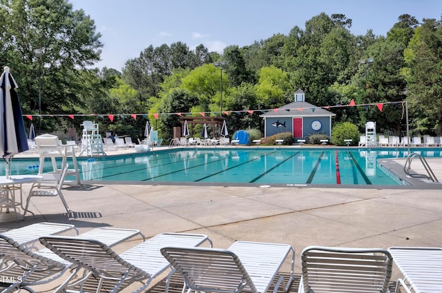 1003 E Sterlington Pl, Apex, NC 27502 - community pool with a patio and view of scattered trees