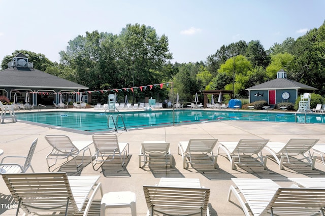 1003 E Sterlington Pl, Apex, NC 27502 - community pool with a patio and view of scattered trees