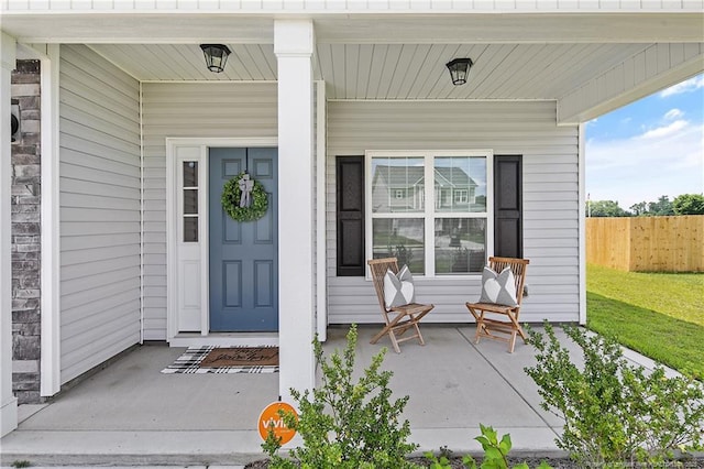 633 Amusement Dr, Hope Mills, NC 28348 - doorway to property featuring a porch and fence