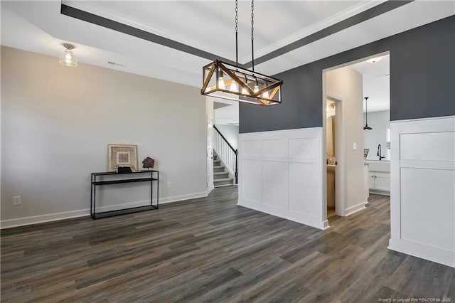 633 Amusement Dr, Hope Mills, NC 28348 - unfurnished dining area featuring dark wood-style flooring, a chandelier, crown molding, a sink, and baseboards