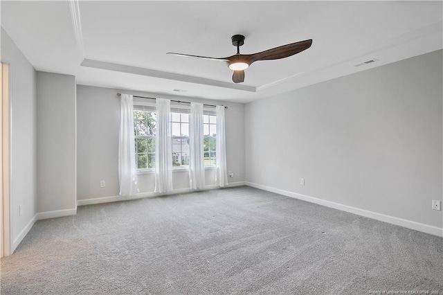 633 Amusement Dr, Hope Mills, NC 28348 - carpeted empty room featuring a raised ceiling, ceiling fan, and baseboards