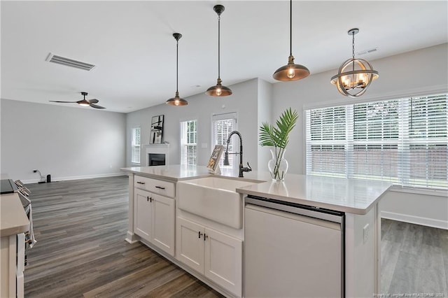 633 Amusement Dr, Hope Mills, NC 28348 - kitchen with dishwashing machine, a sink, light countertops, and dark wood-type flooring