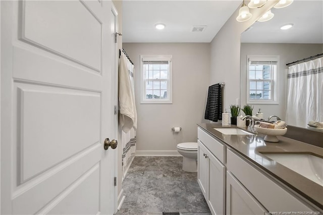633 Amusement Dr, Hope Mills, NC 28348 - full bath with healthy amount of natural light, baseboards, toilet, and double vanity