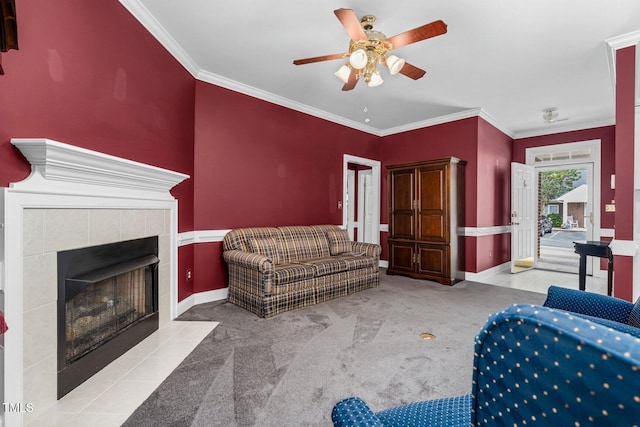 106 Irene Ct, Rocky Mount, NC 27804 - living room featuring a ceiling fan, crown molding, a tile fireplace, baseboards, and carpet floors