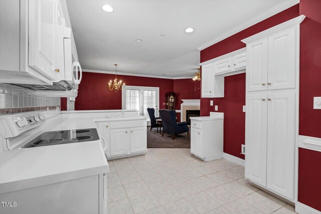 106 Irene Ct, Rocky Mount, NC 27804 - kitchen with white electric stove, crown molding, a peninsula, a chandelier, and white cabinetry