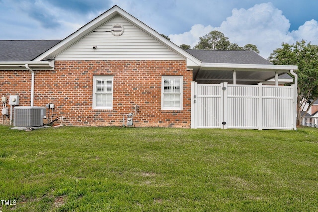 106 Irene Ct, Rocky Mount, NC 27804 - rear view of house with cooling unit, brick siding, and a shingled roof