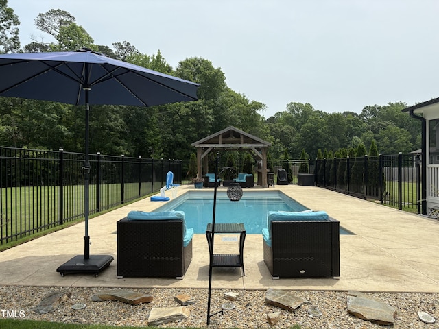 view of pool with a gazebo, fence, and a patio area