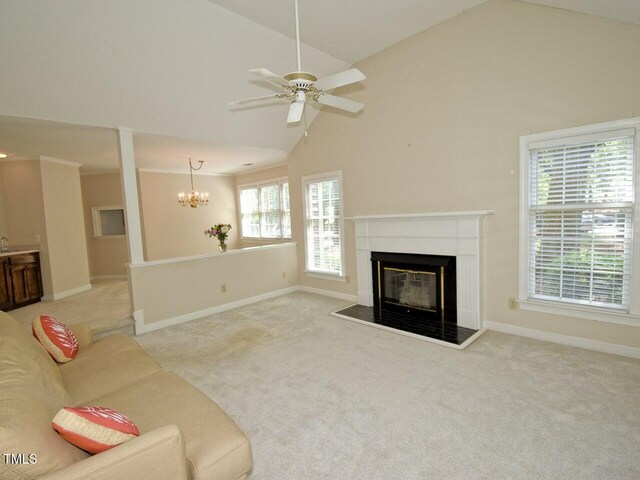 119 Long Shadow Ln, Cary, NC 27518 - unfurnished living room with a glass covered fireplace, light colored carpet, a chandelier, baseboards, and high vaulted ceiling