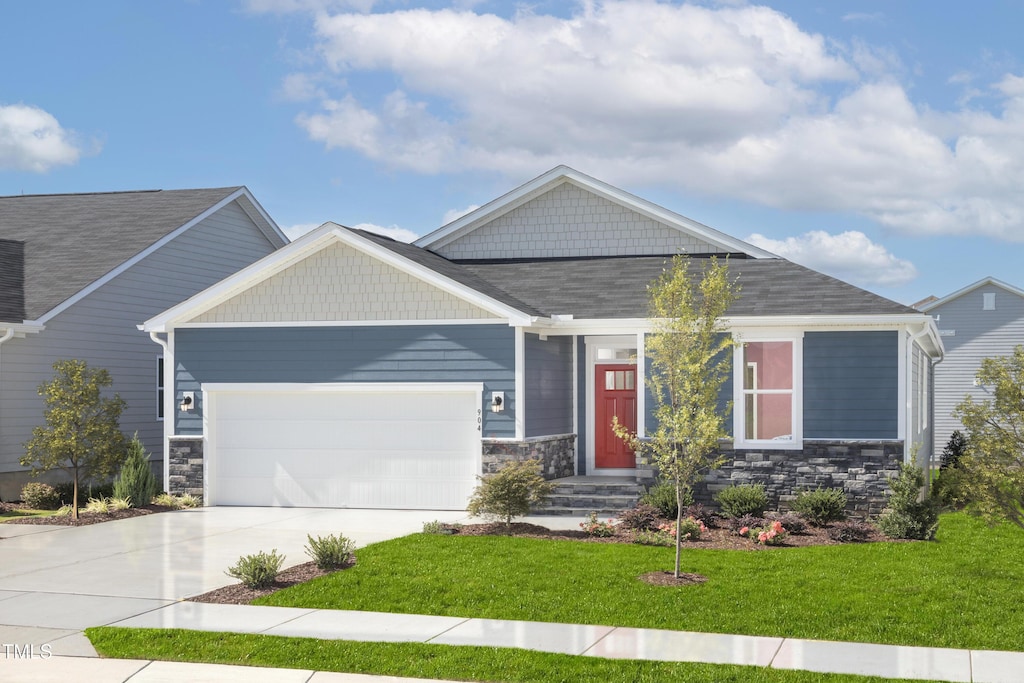 904 Emmer St, Rolesville, NC 27571 - craftsman house featuring an attached garage, concrete driveway, a front yard, and stone siding