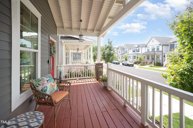wooden deck featuring a porch and a residential view