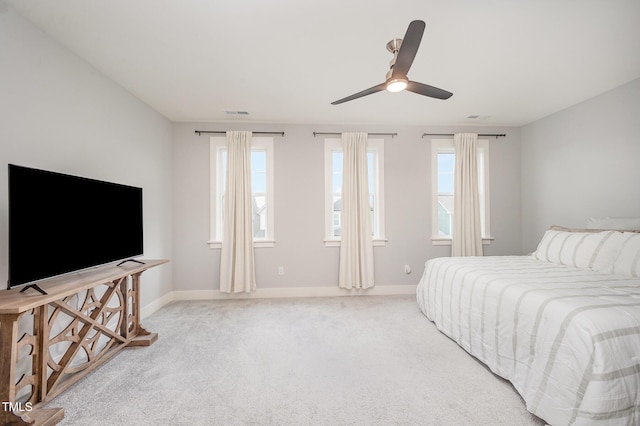 bedroom with multiple windows, baseboards, and carpet