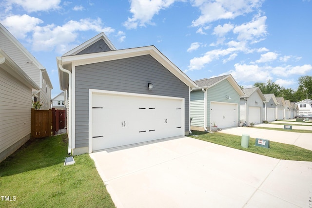 view of front of house with concrete driveway, a residential view, and a garage