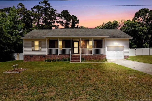 single story home with crawl space, an attached garage, concrete driveway, and a porch