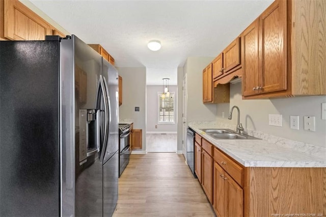 kitchen with stainless steel refrigerator with ice dispenser, a sink, dishwashing machine, range with electric cooktop, and light wood-style floors