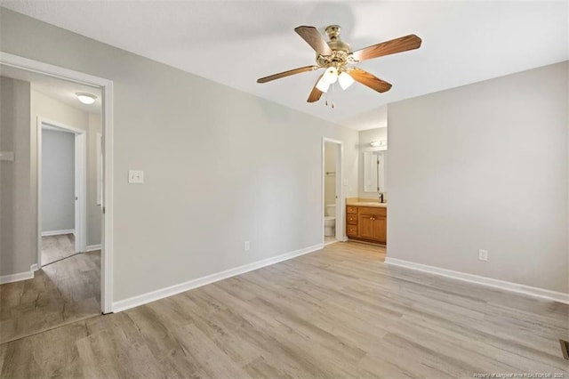 spare room with light wood-type flooring, ceiling fan, and baseboards