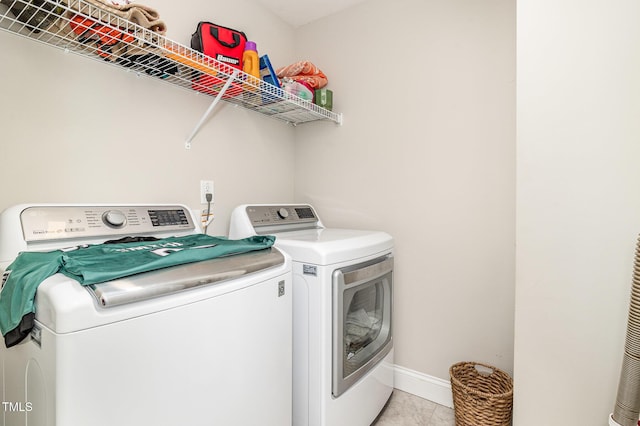 111 Laporte Path, Garner, NC 27529 - washroom with washing machine and dryer, baseboards, and light tile patterned floors