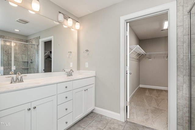 111 Laporte Path, Garner, NC 27529 - full bath with a walk in closet, double vanity, a stall shower, baseboards, and tile patterned floors