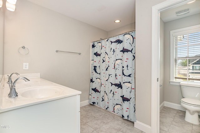 111 Laporte Path, Garner, NC 27529 - full bathroom with tile patterned flooring, toilet, baseboards, double vanity, and recessed lighting