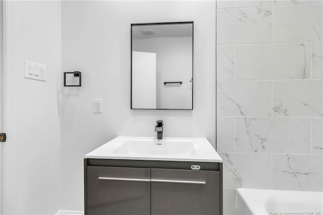 bathroom with vanity and a tub to relax in