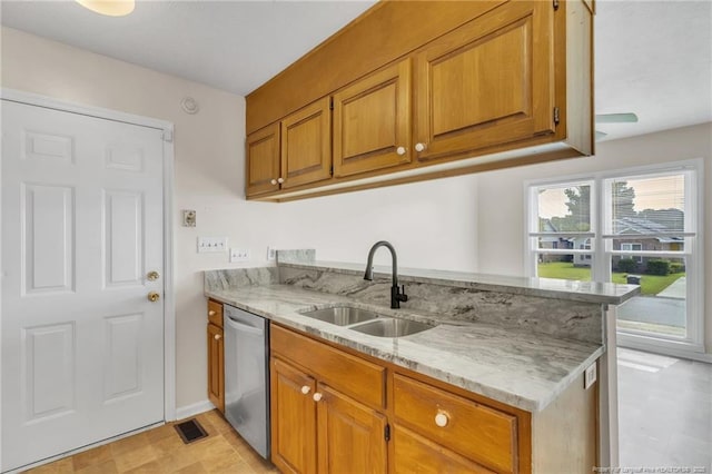 2256 Spindletree Dr, Fayetteville, NC 28304 - kitchen with a sink, dishwasher, brown cabinets, and light stone counters