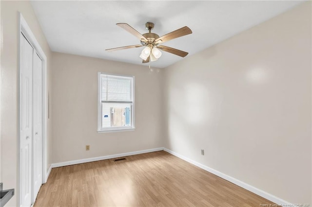 2256 Spindletree Dr, Fayetteville, NC 28304 - unfurnished bedroom featuring a closet, light wood-style floors, baseboards, and a ceiling fan