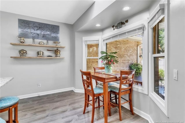 dining space featuring wood finished floors, baseboards, and recessed lighting