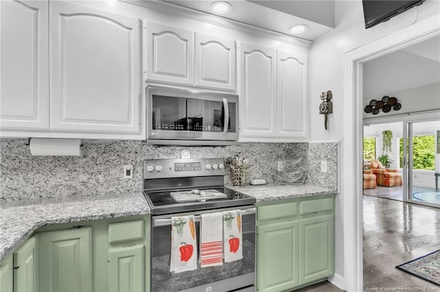 kitchen featuring stainless steel appliances, white cabinetry, backsplash, green cabinetry, and recessed lighting