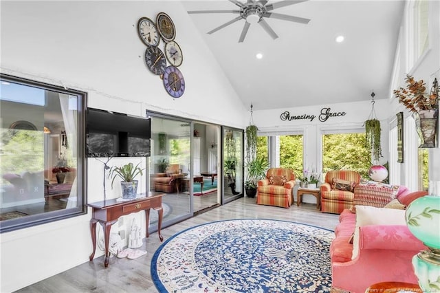 sunroom / solarium with high vaulted ceiling, wood finished floors, and recessed lighting