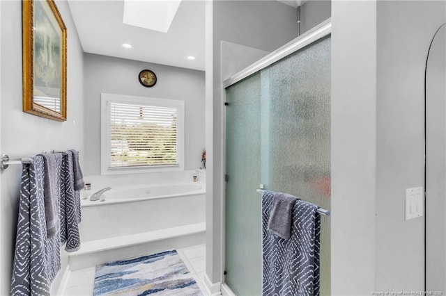 full bath featuring a skylight, a bath, a shower stall, and recessed lighting