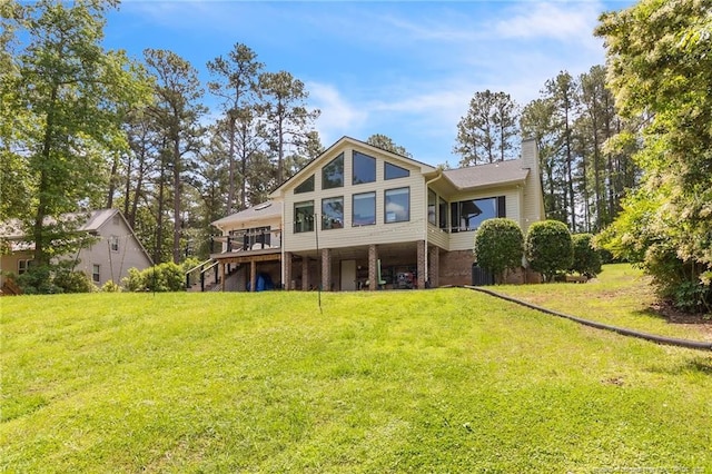 back of house with a chimney, stairs, a lawn, and a wooden deck