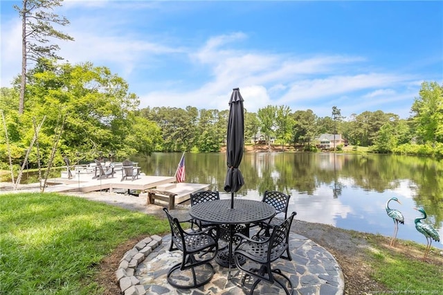 dock area with a water view and view of scattered trees