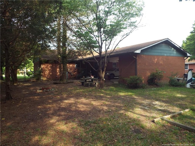 back of property featuring brick siding
