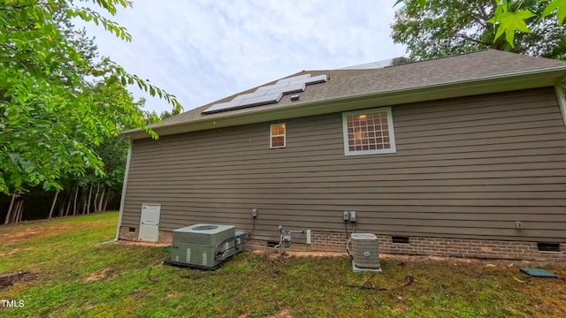 99 Grassy Creek Way, Chapel Hill, NC 27517 - view of side of home with crawl space, roof mounted solar panels, a yard, and a shingled roof