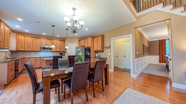 99 Grassy Creek Way, Chapel Hill, NC 27517 - dining area with a chandelier, light wood-style floors, a wainscoted wall, and recessed lighting