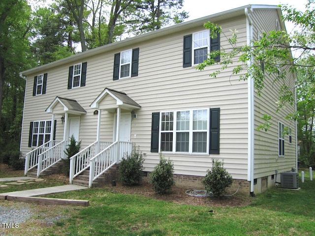 view of front of home featuring central air condition unit, crawl space, and a front yard