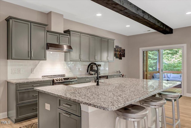 10304 Stallion Way, Bahama, NC 27503 - kitchen with stainless steel electric stove, light wood-style floors, light stone counters, under cabinet range hood, and beam ceiling
