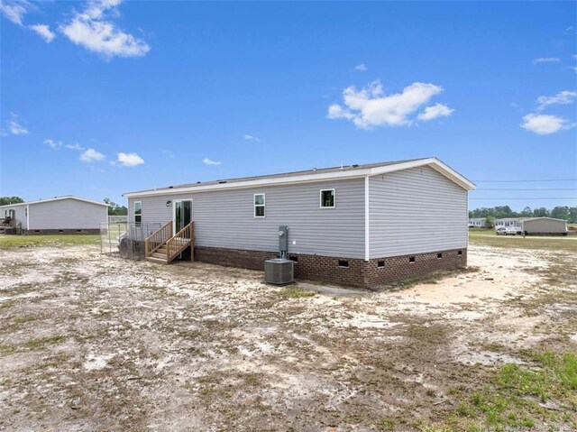 182 Ajax Dr, Saint Pauls, NC 28384 - rear view of house featuring crawl space and central AC