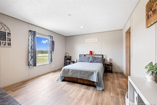 182 Ajax Dr, Saint Pauls, NC 28384 - bedroom with light wood-style flooring, a textured ceiling, and recessed lighting